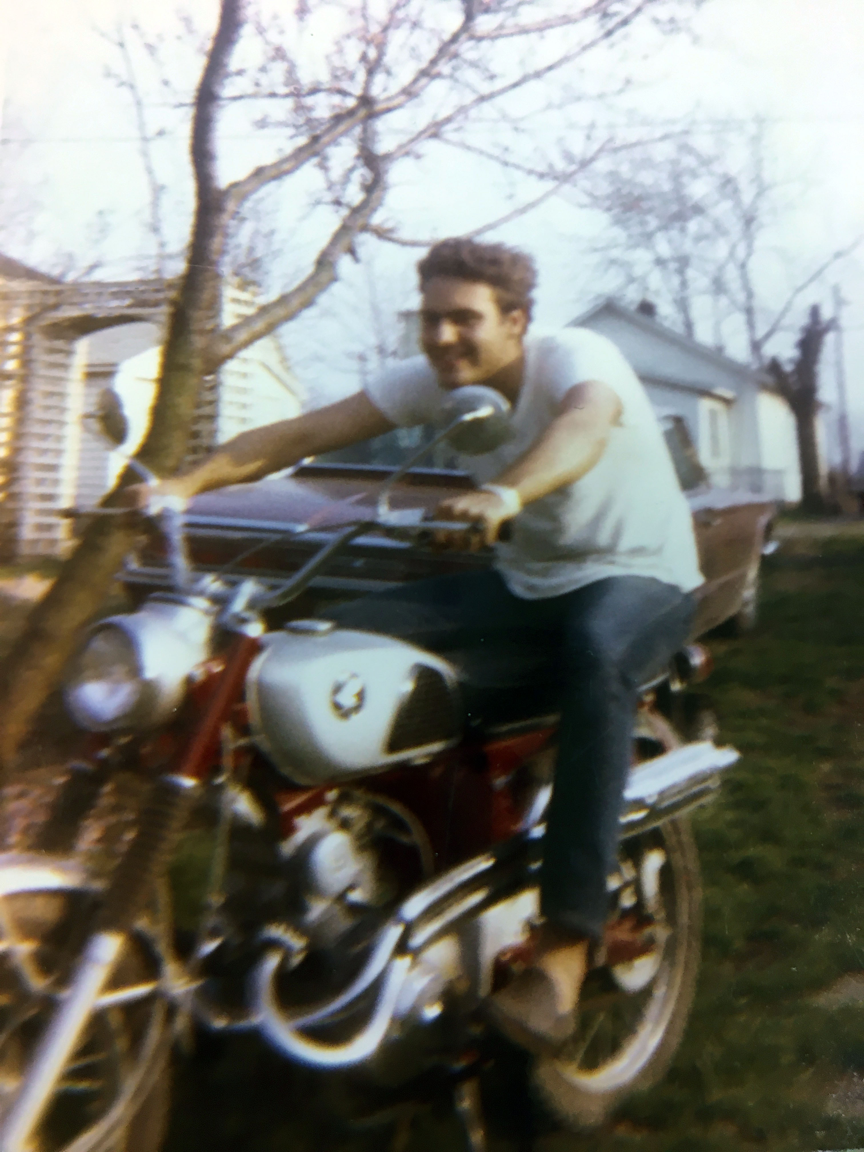 cool dad Gene Bradley rides a motorcycle in vintage photo